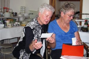 Soroptimists Marilyn Brown (right) and Marjorie Rorabaugh discuss pricing during a recent estate sale in Washougal.