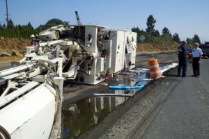 A pavement grinder tipped over earlier this afternoon on state Route 14 in Washougal, blocking the roadway in both directions. The driver received only minor injuries.