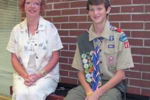 Michael Knight sits with Liberty Middle School Principal Marilyn Boerke on one of the five benches he made for the school as a part of his Eagle Scout project last year.