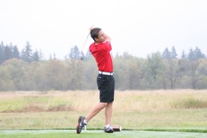 Braeden Campbell watches his tee shot sail over the wetlands that surround the Camas Meadows golf course. The Union Titans defeated the Camas Papermakers by one stroke Thursday, 150-151.