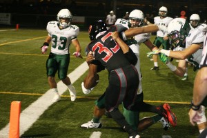 Bryan Kelly takes on a bunch of Plainsmen at the goal line. The Camas High School senior rushed for 187 yards and scored two touchdowns to help the Papermakers prevail 49-7.