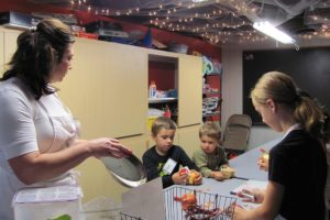 Danielle Frost/Post-Record
Heidi O'Connor, executive director of The Kids Cooking Corner, instructs her students on how to safely peel an apple. The group made pie, festive salad, and a cheesy butternut squash casserole.