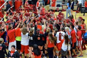 Camas volleyball players, coaches and fans celebrate after the Papermakers beat Battle Ground Sept. 30, at Camas High School.