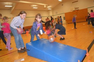 Cape Horn-Skye Elementary student Haleigh Byrd (left) helps Allison Drake during the recent Sport-a-Thon. The event raised more than $6,000 for the school.