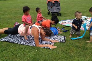 Baby Boot Camp attendees incorporate their children into many components of the exercise routine. Here, local franchise co-owner Mignon Cejalvo (back)  and Lana Gensitskiy do planks with the help of Cejalvo's triplets.