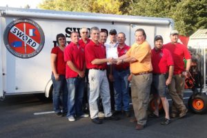 Contributed photo
Georgia-Pacific Camas mill manager Gary Kaiser (right) presents a check for $10,000 to members of the S.W.O.R.D. team including Misty Metz, Tyler McMahon, Larry Wagoner, Tim Woodring, Doug Young, Ron Gray, Jerry Lester, Jim Virgin and Luke McCall.