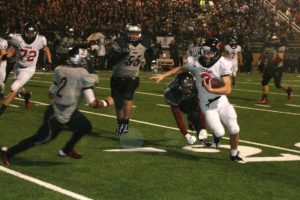 Zach Eagle weaves around the Union defenders Friday, at McKenzie Stadium. The Camas High School junior had a touchdown catch, a fumble recovery and an interception to help the Papermakers beat the Titans 22-0.