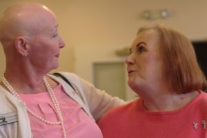 Jennifer McDaniel, who is battling breast cancer, exchanges a hug with friend and seven-year breast cancer survivor Janet James at the Columbia Ridge Senior Living Pink Tea Party last week. October is National Breast Cancer Awareness Month.