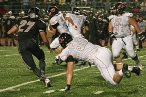 Camas running back Cole Zarcone runs through a giant gap created by linemen Dakota Napierkowski, Chase Lea and Alex Walker Friday, at McKenzie Stadium. Zarcone scored three touchdowns to help the Papermakers beat Union 37-20.