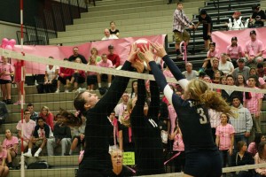 Cassie Bailie watches her Camas teammates Christina Elliott and Carly Banks double team a Skyview player Thursday. Bailie organized the "Dig For A Cure" event as her senior project.