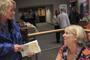 Author Cheryl Linn Martin visits with a fan at the book release party at Journey Community Church.