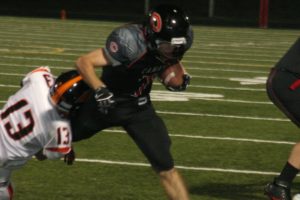 Nate Beasley bowls over a Battle Ground Tiger Friday, at Doc Harris Stadium. The Camas High School junior had two touchdown runs and an interception on defense. See the photo gallery at www.camaspostrecord.com.