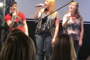 The Niles daughters are all actively involved in the worship service at their parents' new church.  Here, from left to right, Savvy, Bethany and Jessica Niles perform at a youth retreat in Salem.