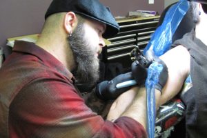 Ryan "Boomer" Boomhower creates a tattoo for Traci Grieve, at 3rd Heart Tattoo, in downtown Washougal. Boomhower opened the new business on Oct. 24. He has been a tattoo artist for more than eight years.