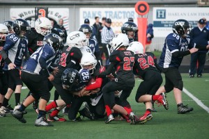 The Camas Cardinals Black fourth- and fifth-graders stop the Hockinson Hawks short of a first down during the Clark County Youth Football Junior Division championship game Saturday, at District Stadium, in Battle Ground. The Cardinals won 32-13.