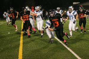 Brandon Casteel inches closer to the end zone for one of his three final touchdowns Friday, at Fishback Stadium. Washougal shutout Mark Morris 27-0 to finish the season with a 5-4 record.