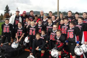 Fourteen Camas High School football players surprised the fourth- and fifth-grade CCYF Camas Cardinals by showing up at their playoff game Saturday, at Fishback Stadium. The Cardinals defeated the Hawks 20-19 in double overtime.