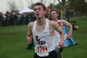 Washougal senior Sean Eustis comes from behind to beat Devon Grove of Lake Washington to the finish line in the 2A state championship race Saturday, at the Sun Willows golf course in Pasco. Eustis earned fourth place in 15:39.7. For more Washougal photos, visit www.camaspostrecord.com.