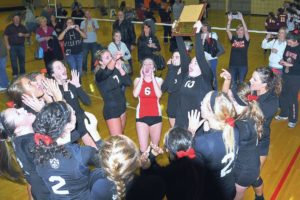 The Camas High School volleyball players celebrate winning the bi-district championship Saturday.