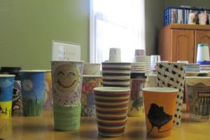 Michelle's Coffee Corner in Washougal is auctioning off decorated cups as a fundraiser for the arts program at Excelsior High School.