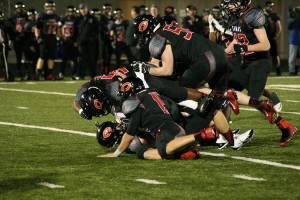 The Papermakers bury a Monroe Bearcat on Doc Harris Stadium turf Friday. Camas won the playoff game 55-20 to get back to state.