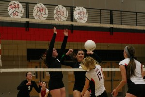 Camas seniors Abbie Younkin (11) and Lauren Neff (2) dunked the volleyball on a Union Titan. The Papermakers finished in fifth place at the state tournament after beating Monroe Friday and Union and Puyallup Saturday at Saint Martin's University.