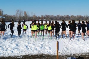 Eight inches of snow greets runners at the start of the Nike Cross Northwest Regional Saturday, in Boise, Idaho. Camas Milltown Project club members Alissa Pudlitzke, Maddie Woodson, Emma Jenkins, Kaylee Merritt, Emily Wilson, Gabrielle Postma and Brooke Roy (wearing green) captured first place at the 16-team meet.