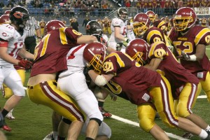 O'Dea puts the squeeze on Camas running back Nate Beasley Friday, at the Tacoma Dome. The Papermakers made it a one-point game heading into the fourth quarter, before the Fighting Irish prevailed 21-13.