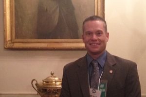 Jeff Snell, Camas School District deputy superintendent, poses under a portrait of President John F. Kennedy during a superintendents' symposium at the White House. He also had the opportunity to hear President Barack Obama speak about a new education initiative to improve access to technology.