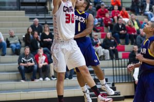 Trevor Jasinsky dunks the basketball on opening night for Camas Monday. He also nailed seven threes for a total of 31 points to help the Papermakers beat Columbia River 66-64.