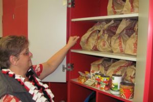 Edie Hagstrom, social worker at Helen Baller Elementary School, prepares bags of food for the school's weekend backpack program, which provides easy to prepare meals and snacks for children in need.