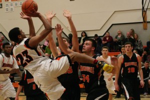 Yorro Bah hangs in there to score a basket during a scrimmage game at Washougal High School. The Panthers start the season at Battle Ground Friday. Tip off is at 7 p.m.