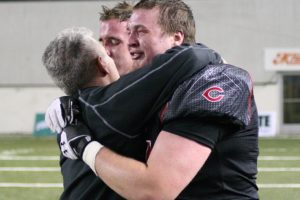 Coach Jon Eagle consoles Drew Clarkson and Matt Walser after an emotional and dejected end.