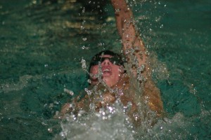 Lucas Ulmer leaves a trail of water droplets in his wake while swimming the 100-meter backstroke for Camas Thursday, at David Douglas High School in Portland, Ore. Ulmer earned second place in the backstroke and the butterfly events.