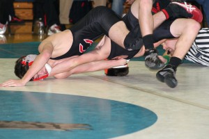 Austin Miller hyperextends his opponent Friday, at La Center High School. Miller and the Camas Papermakers won both matches.