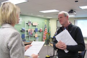 Dawn Tarzian, Washougal School District superintendent, administers the oath of office to Bruce Westfall, the newest School Board member.