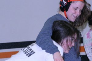 Erin Locke hugs teammate Christina Murray after a tussle in the jungle Thursday, at Washougal High School.