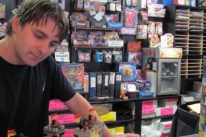 Jake Peterson, a consultant at Hero Support, works on a Lego set. Legos, new and used, are one of the many stocking stuffers available for under $15 at the store.