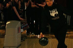 Emily McDonald turns the bowling ball loose Wednesday at Big Al's, while Hunter Lytle, Rebekah Curtis, Katie Hull and Porsche Chartrand cheer her on. The Camas girls knocked down a school record 1,764 pins, but it wasn't enough to beat Kelso.