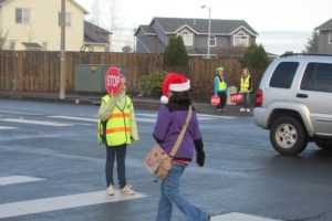 Fifth-grader Laura Teames (left) helps a student cross the busy intersection at Northwest 28th Avenue and Sierra Drive near Dorothy Fox Elementary School in Camas.