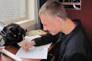 Neumann's cat, Kanga, is a constant companion at his desk while he composes music.