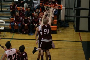 Michael McElory climbs the bean stalk and scores a basket for the Washougal boys basketball team.