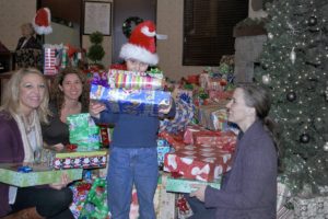 Riverview Community Bank employees recently donated 400 gifts to foster children through the organization's "Shirley DuPaul -- Gifts for Kids in Care" program. Pictured above (left to right) are Riverview employees Jessica Douglas, Jennifer Konopasek and son Austyn Konopasek, and Gina Williams.