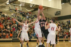 Washougal High School senior Mustapha Bah muscles up for a shot, while two Camas High School defenders try to stop him. The Panters defeated the Papermakers 64-44 Dec. 20, at Camas High School for their eighth win in a row.