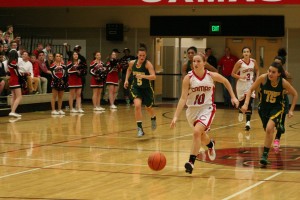 Rachel Rice rides in the fast lane for the Papermakers against Evergreen. The Camas High School senior will be wearing her pink uniform for the last time during Hoops for Pink night Friday, in the Camas warehouse.