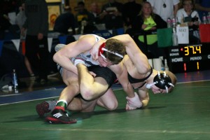 Bryant Elliott attaches to Daniel Rice during the 132-pound Clark County championship match Saturday, at Mountain View High School. The Camas Papermaker beat the Union Titan 15-11.