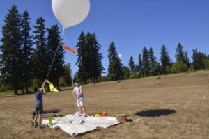 Jaclyn Smith and Chris Robertson of Robertson Engineering use white latex weather blaloons as markers at Jemtegaard Middle School, as part of a site line evaluation before construction. The school is located in the Columbia River Gorge National Scenic Area. 