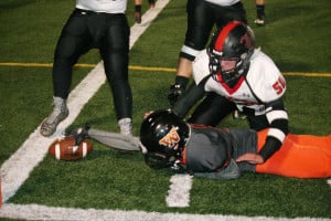 Kade Coons dives across the goal line to score his third touchdown of the game for the Washougal football team Friday, at Fishback Stadium.