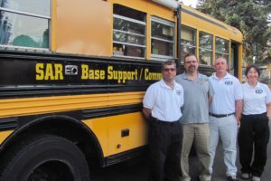 From left, Rick Blevins, Stephen Donahay, Wade Oxford and Jan Foltz enjoy their work as volunteers with Silver Star Search and Rescue. Blevins converted this old school bus into a mobile operations center. 