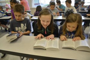 Hathaway Elementary School third-graders Cameron Miller, Chloe Baker and Peyton Del Carlo check out their new dictionaries, which were donated by the Camas-Washougal Rotary Club.